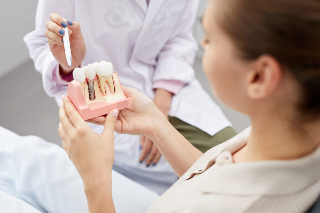 Woman holding dental implant mould 