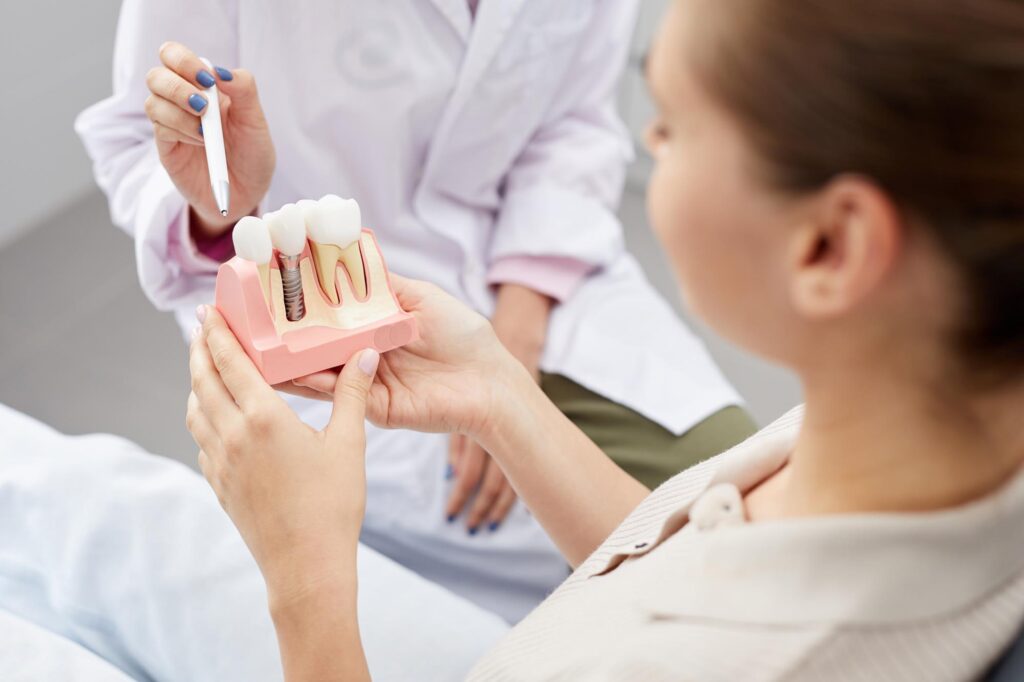 Dental implant model being shown to a patient