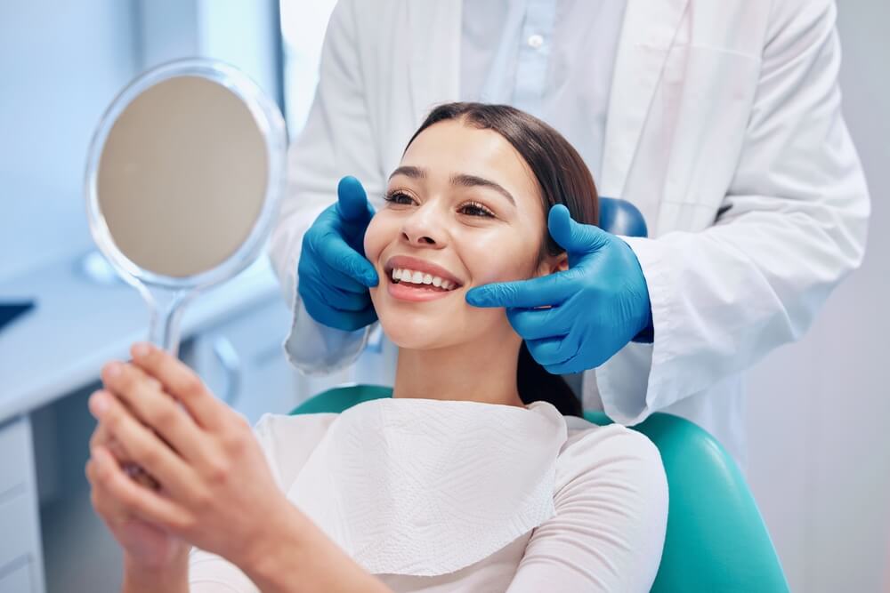 Woman holding a mirror in the dentist
